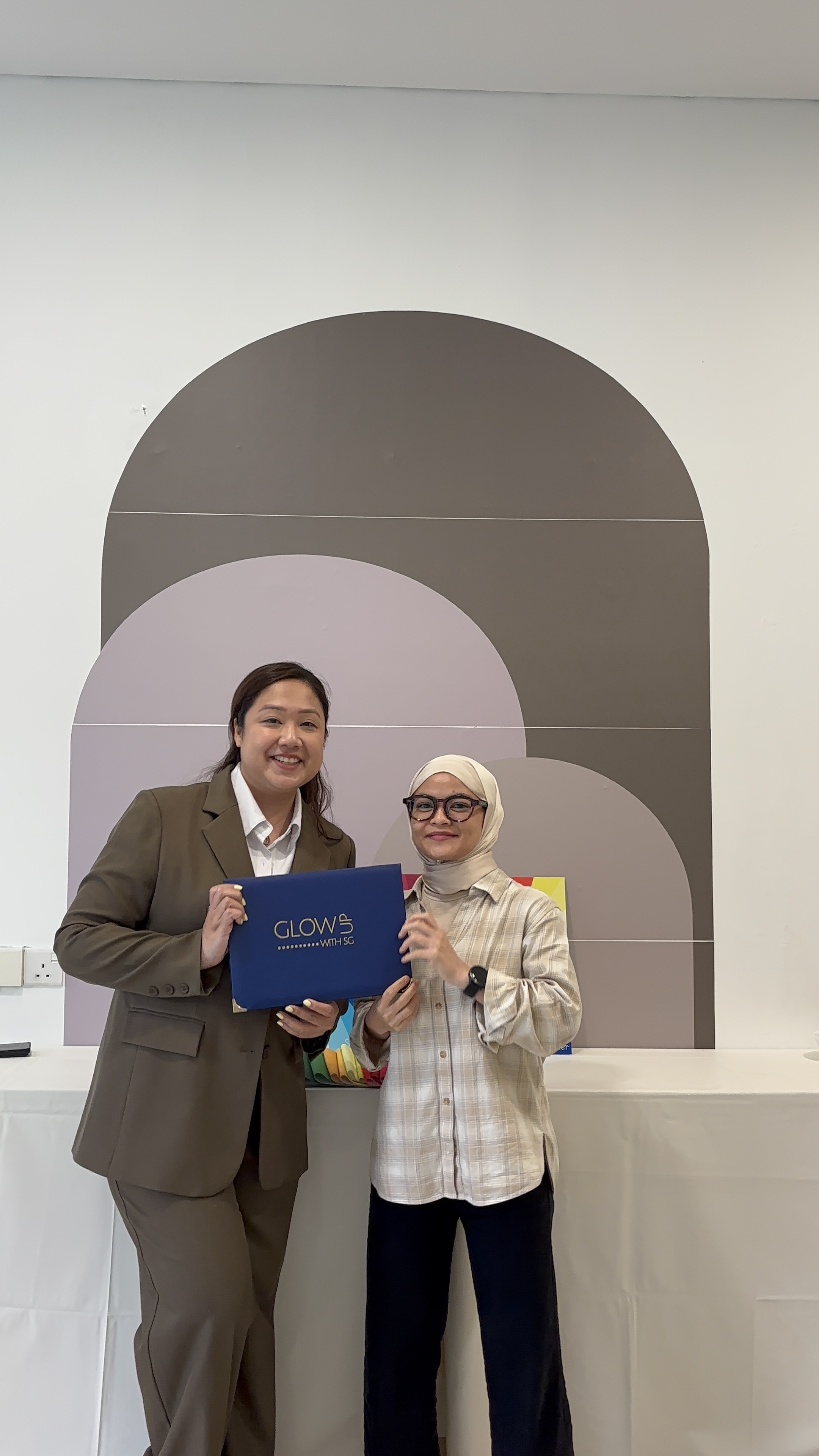 CPCS graduate with Stephenie holding Glow Up with SG folder