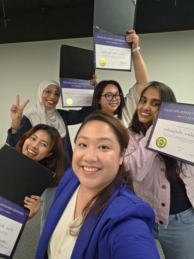 CPCS graduates celebrating together, holding up their certificates